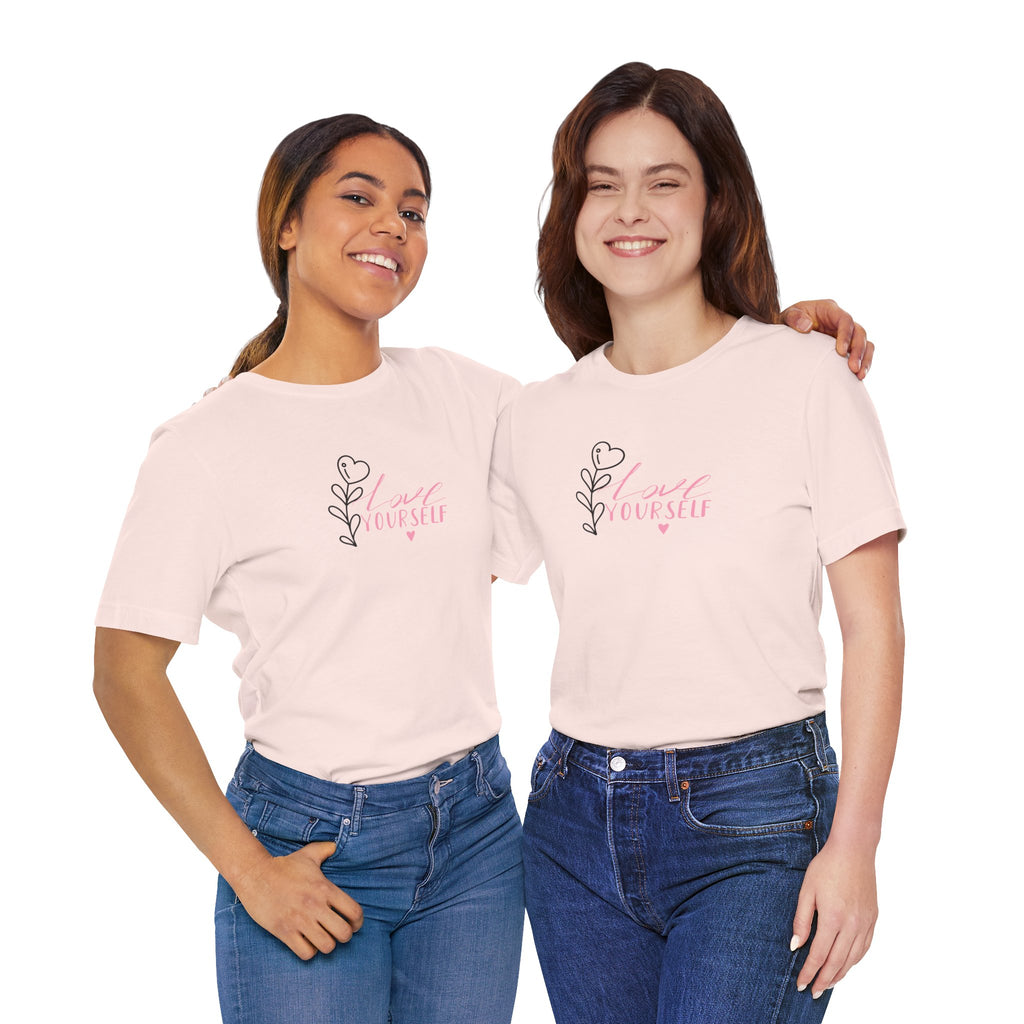 picture of two young women wearing soft pink tee shirt with the text love yourself.  This shirt encourages confidence in  the person that wears it and reads it. 