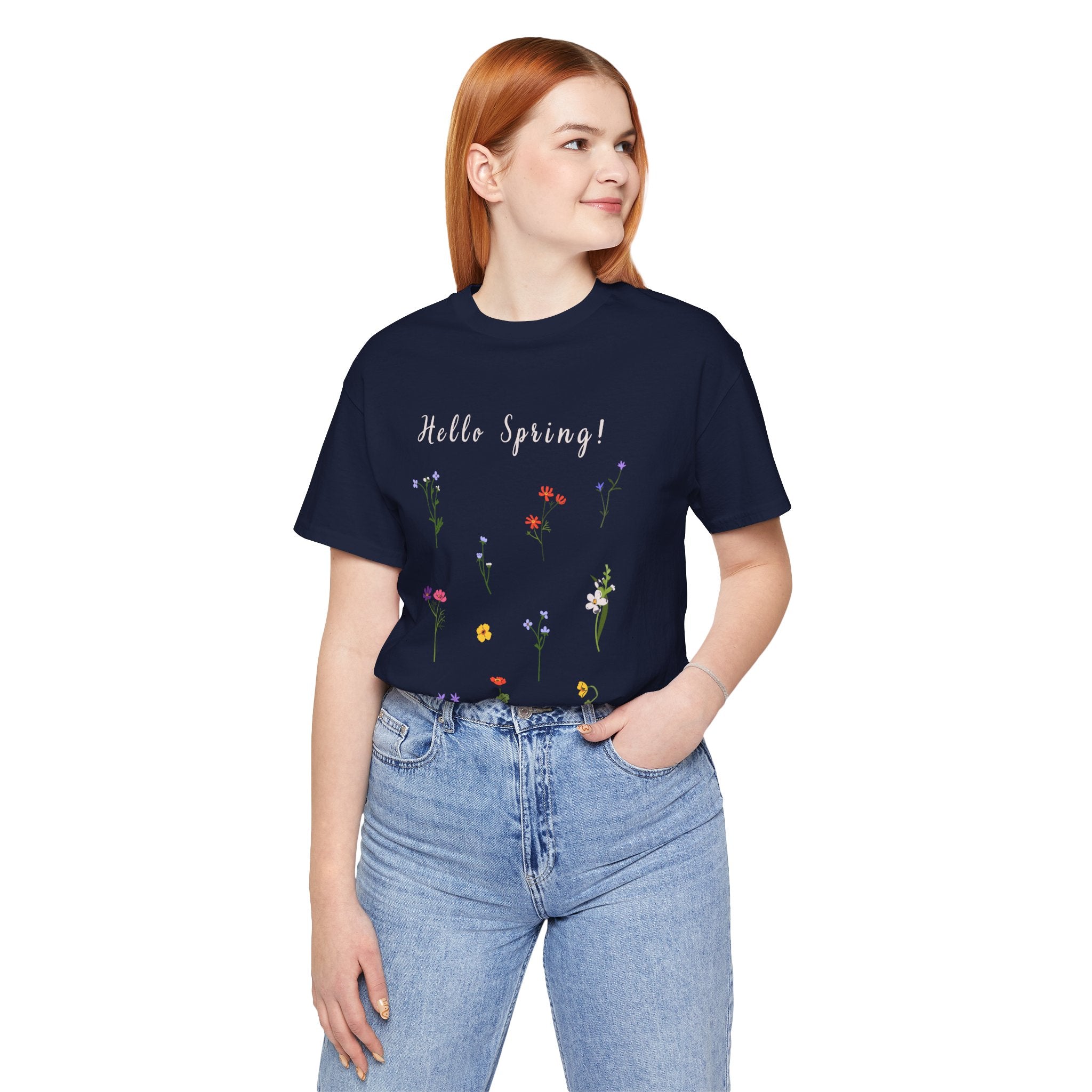 A college student wearing a navy tshirt with the words "Hello Spring!"