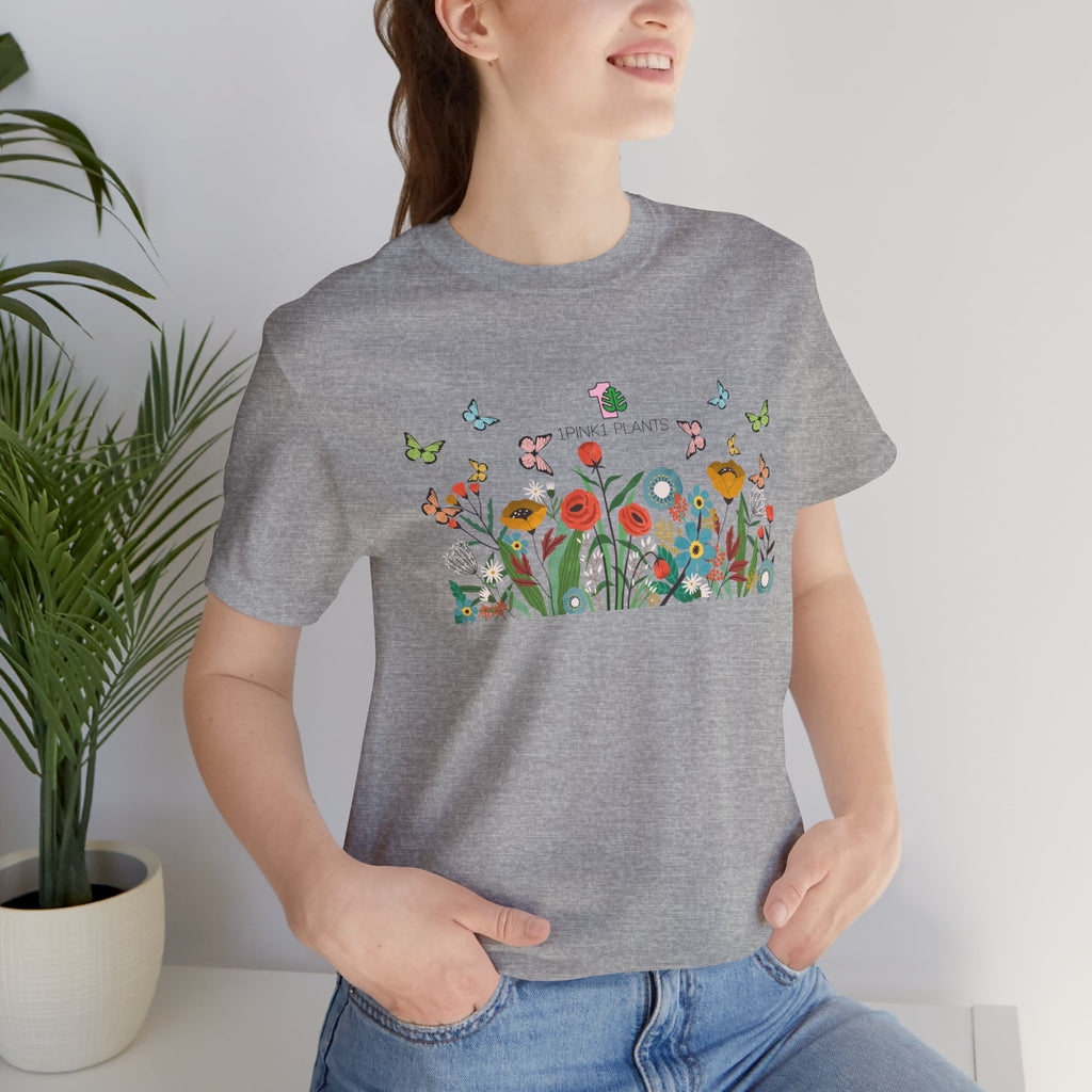 A lady wearing a floral garden design tee shirt