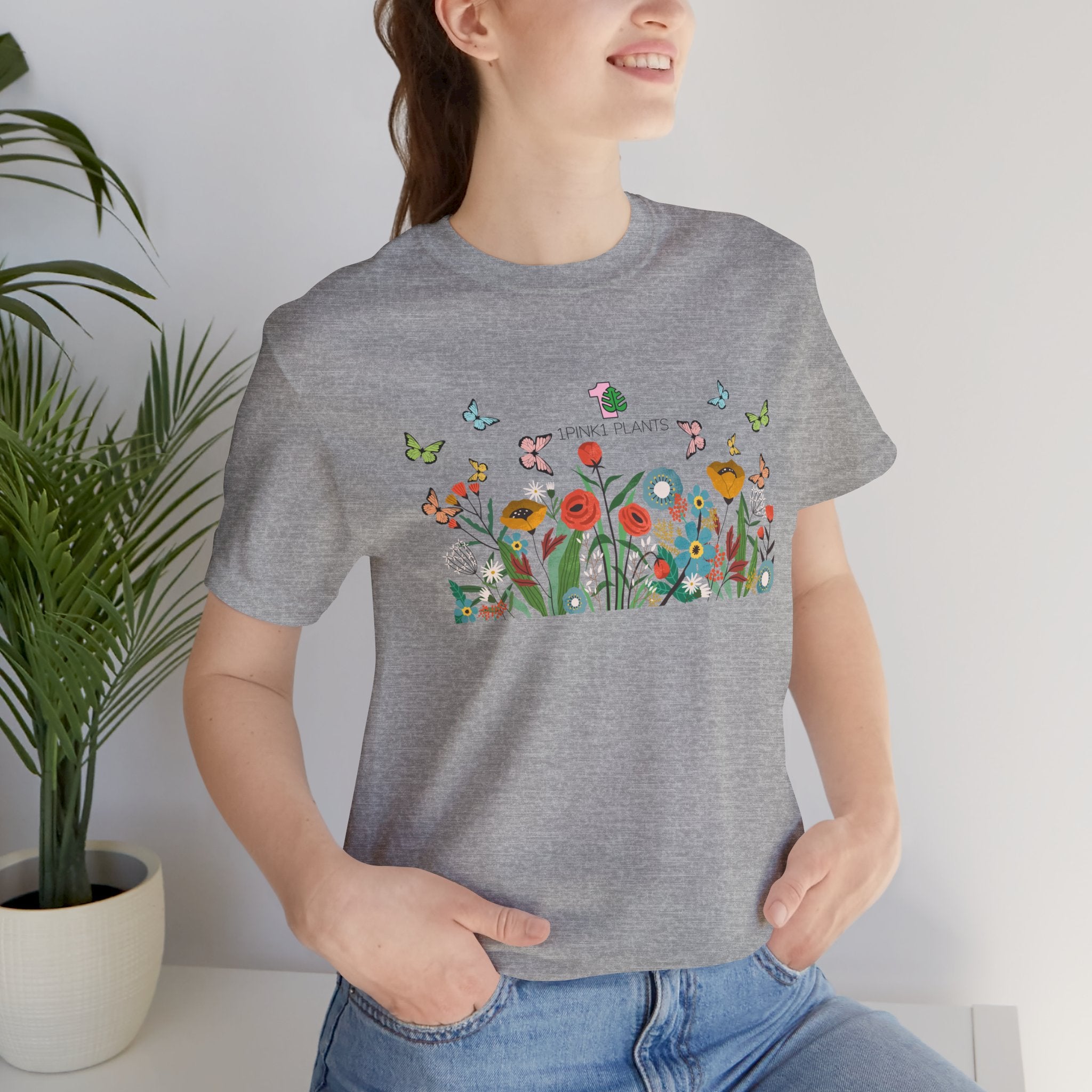 A lady wearing a floral garden design tee shirt