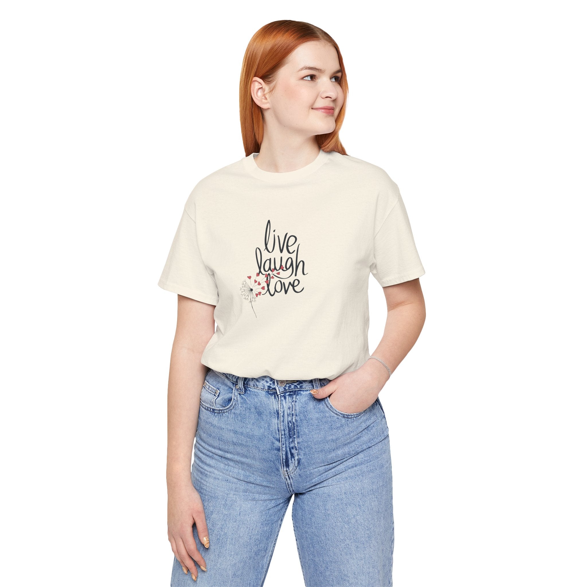 a person wearing a tee with text that says "live, laugh, love," and a dandelion with hearts.