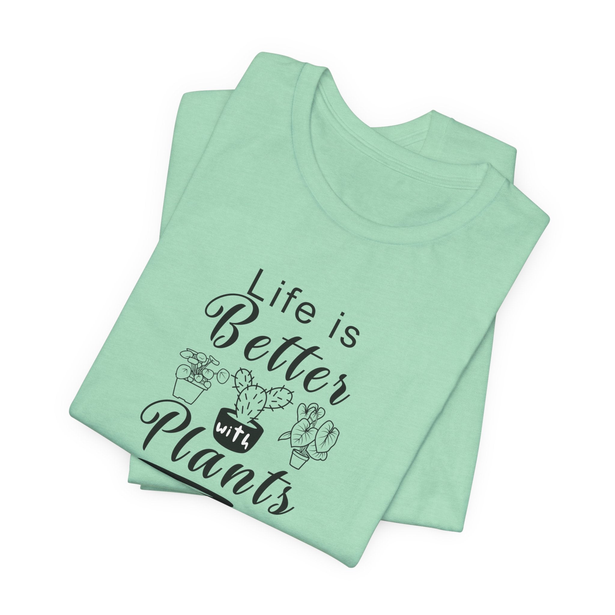 A folded t-shirt with the text "Life is Better with Plants" printed on the front. The shirt comes in a heather mint color.