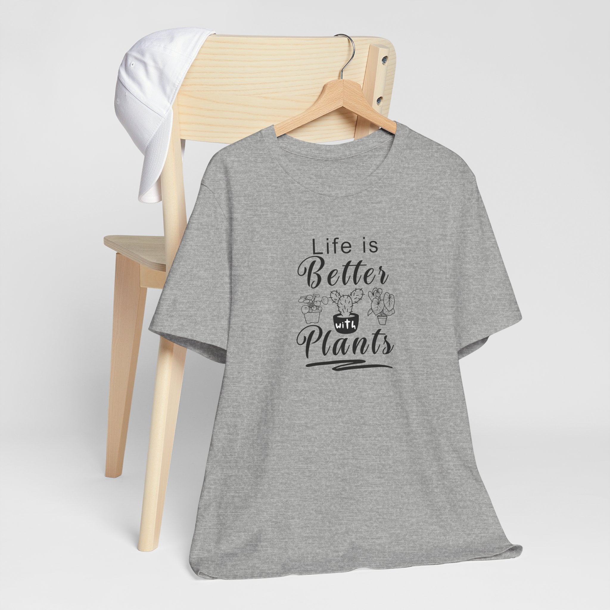 a hanging gray shirt with "Life is Better with Plants" text in black  