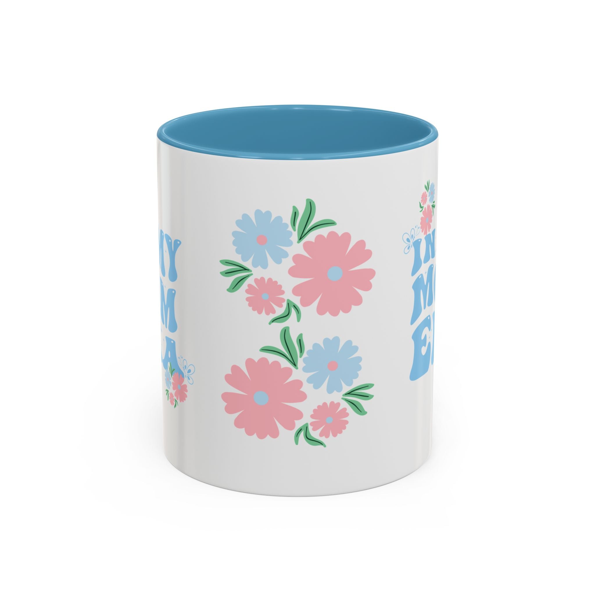 White mug with blue interior, floral design, and text on a white background