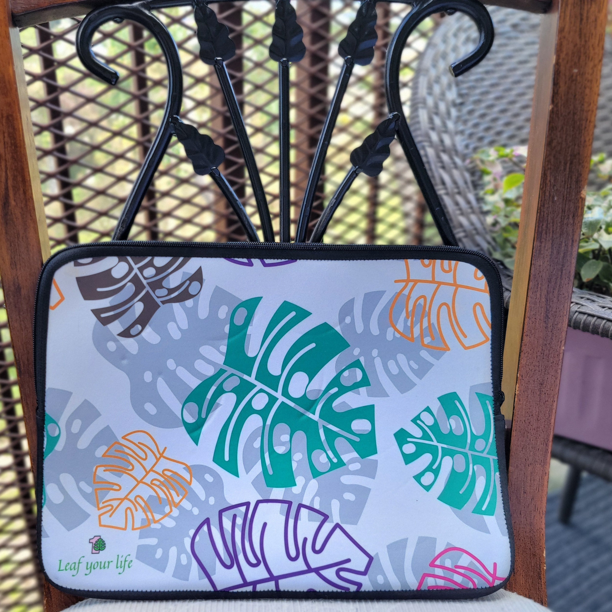 Laptop sleeve with leaf pattern on a chair